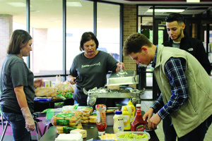 Members of Center Church prepare lunch for several of the dorm students. The church has teamed up with Jo’s coffee shop to bring students food each Sunday.