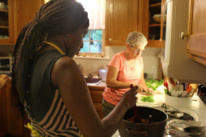 Northeast student Aji Nijie, left, and Morris prepare dinner together at Morris’ house one Friday evening. The professor welcomes students into her home each weekend to share a home cooked meal and a small devotion.